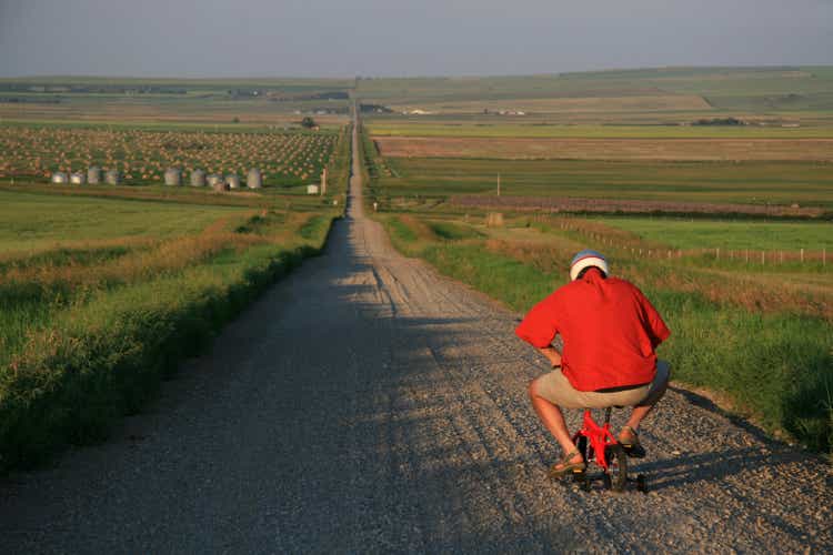 Senior Man Going for a Bicycle Ride on Tiny Bike