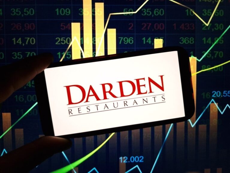 Darden Restaurants logo on smartphone with stock market background