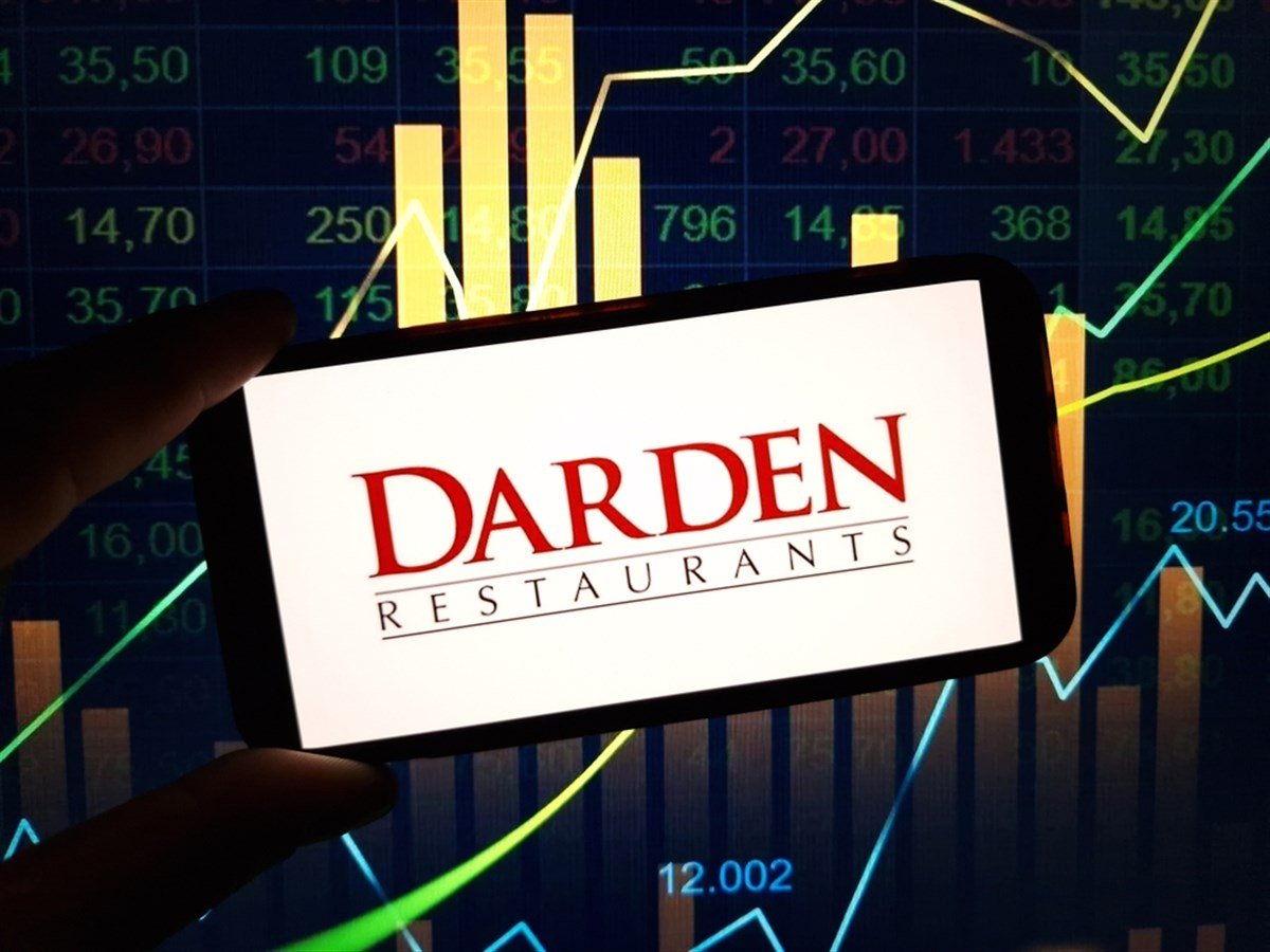 Darden Restaurants logo on smartphone with stock market background