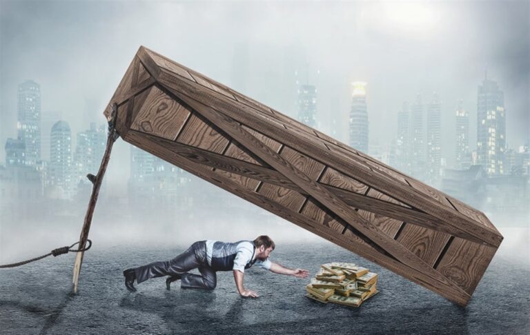 Businessman trying to get money under big wooden box trap. What is a Liquidity Trap?