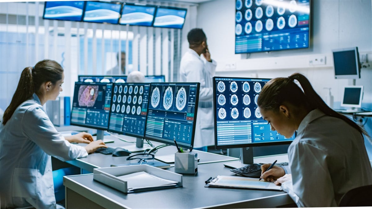 Team of Professional Scientists Work in the Brain Research Laboratory Surrounded by Monitors Showing CT