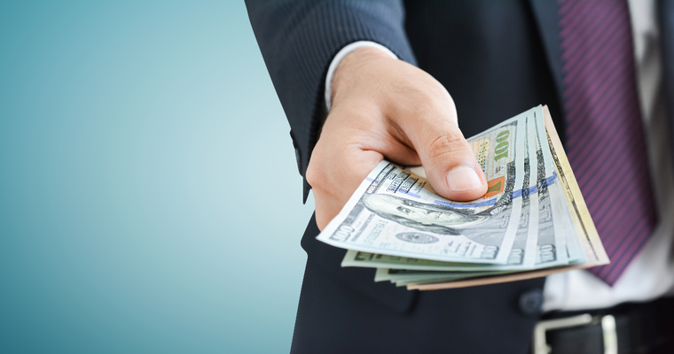 Man in suit handing cash to someone