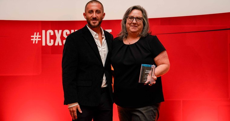 Two people holding award