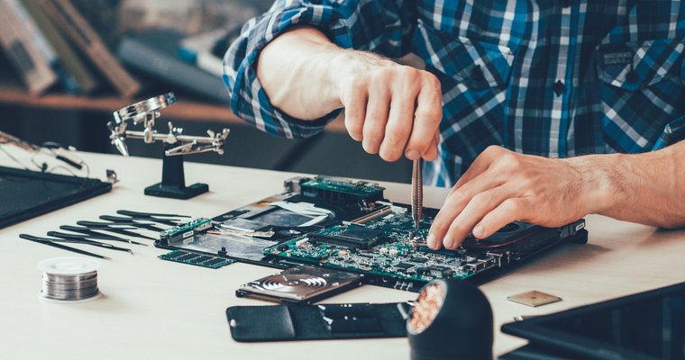 man repairing computer parts