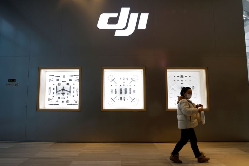© Reuters. A woman walks past a store of Chinese drone maker DJI inside a shopping mall in Beijing, China December 15, 2021. REUTERS/Carlos Garcia Rawlins/ File Photo © Reuters. A woman walks past a store of Chinese drone maker DJI inside a shopping mall in Beijing, China December 15, 2021. REUTERS/Carlos Garcia Rawlins/ File Photo