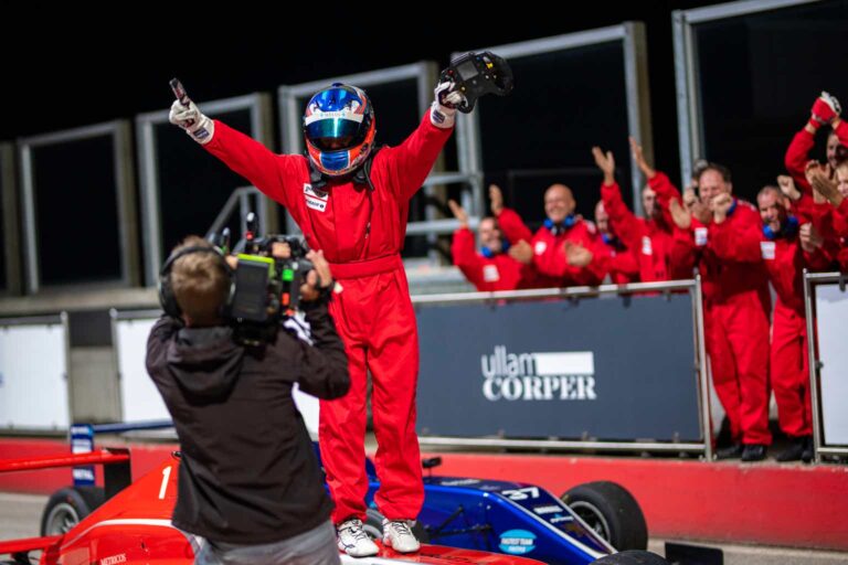 Cameraman interviewing formula driver