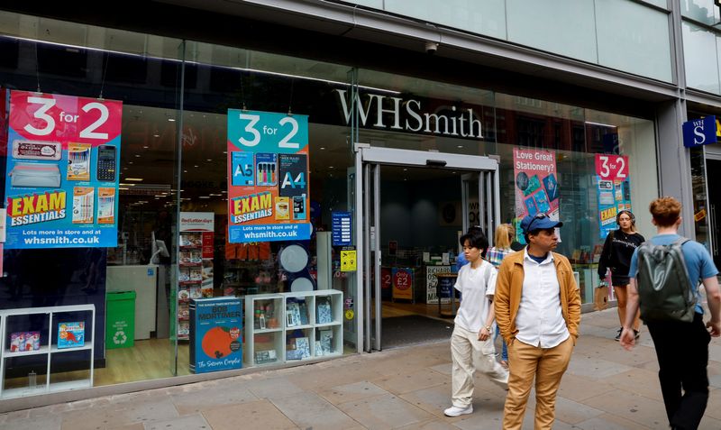 © Reuters. FILE PHOTO: People walk past a WH Smith store in Manchester, Britain, May 26, 2023. REUTERS/Jason Cairnduff/File Photo