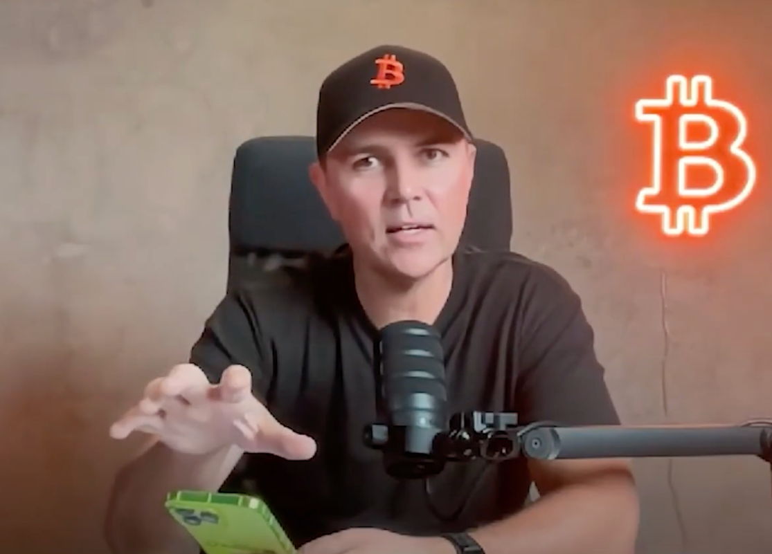 A person sitting in a chair with a microphone and a phone

AI-generated content may be incorrect.