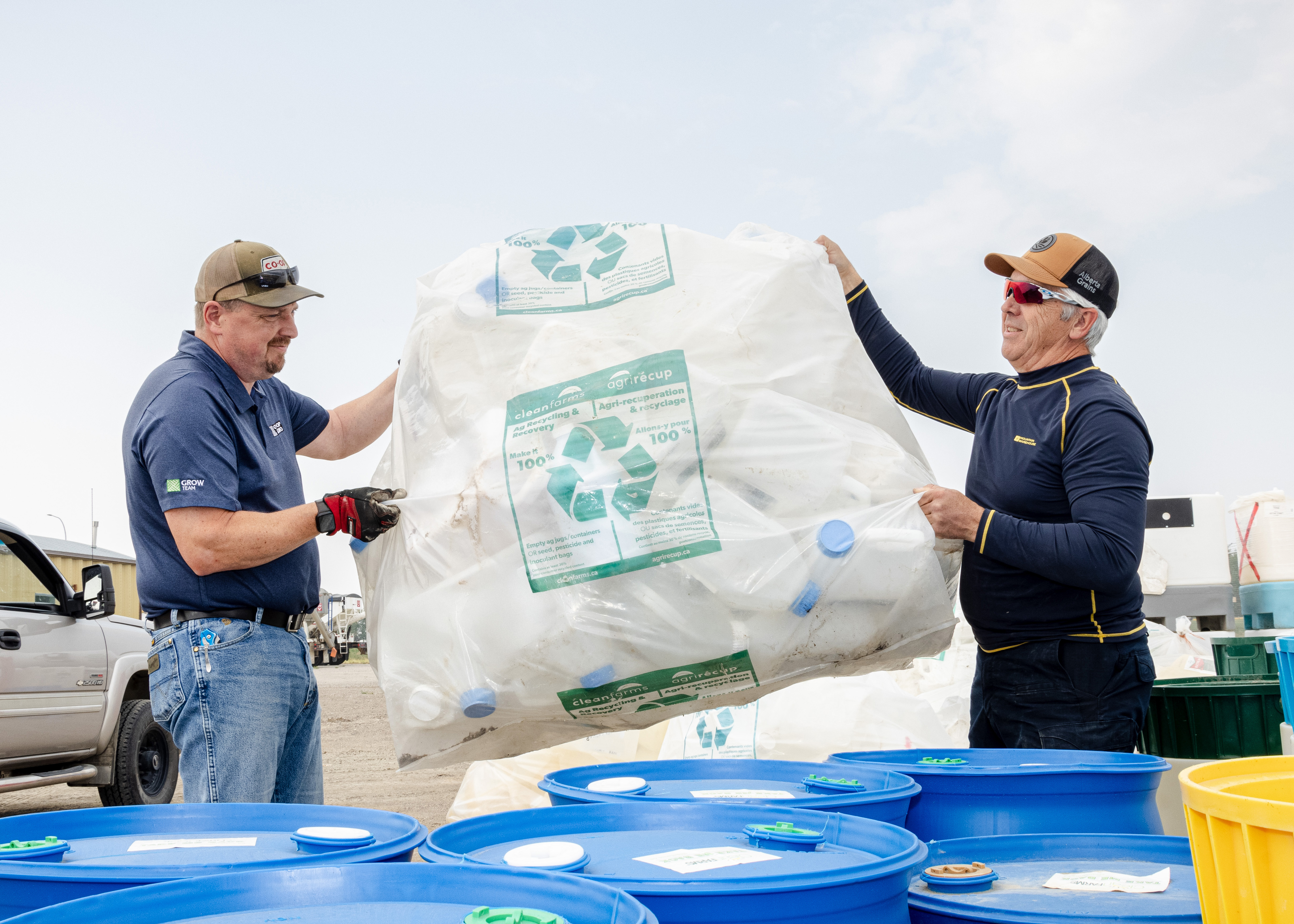 Used ag plastic jugs ready to be collected and recycled by Cleanfarms Farmers' efforts in preparing and transporting used ag plastic jugs to the Cleanfarms site contribute to sustainable agricultural practices by facilitating their recycling.