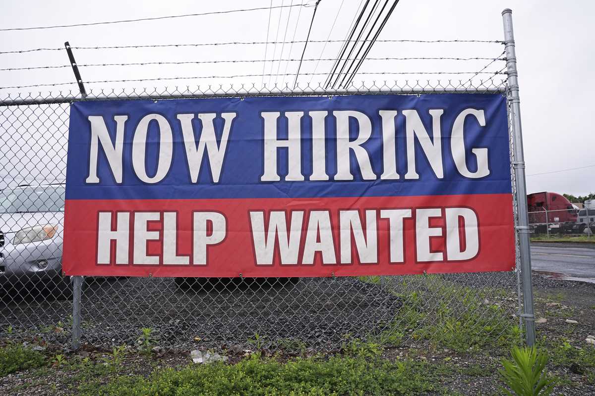 Fewer Americans sought unemployment benefits last week as layoffs remain low