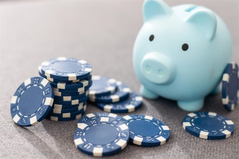 Blue poker chips next to a blue piggy bank