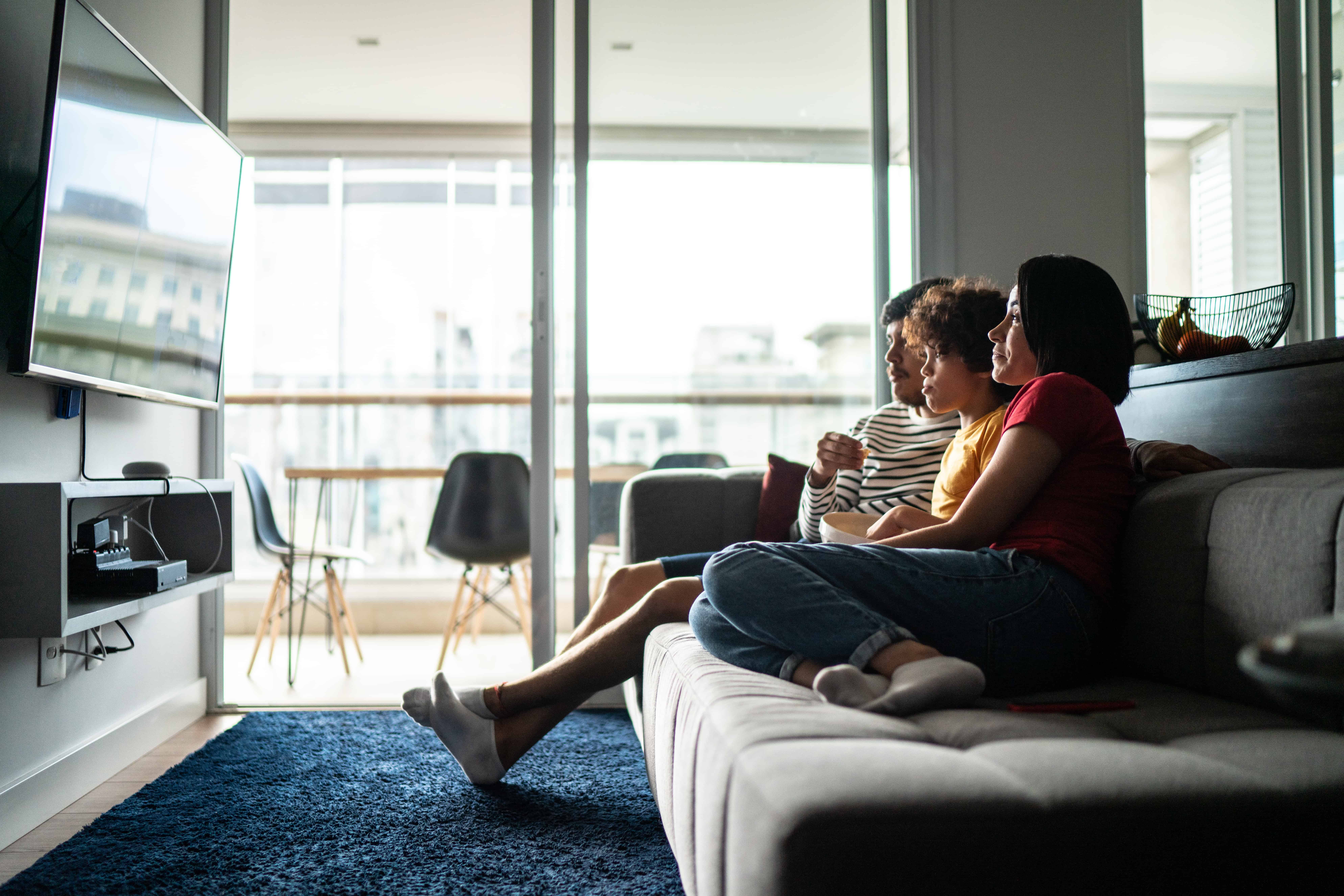 A family watches tv using Roku at home.