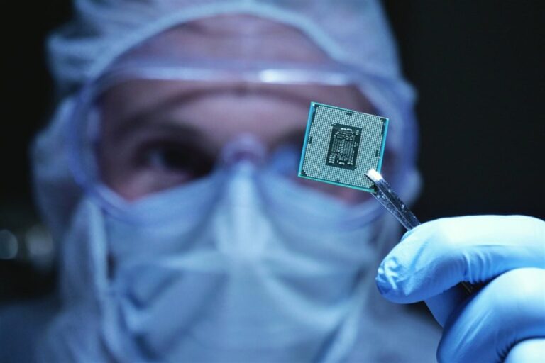 Researched in a sterile environment holds up a microchip with cryogenic packaging