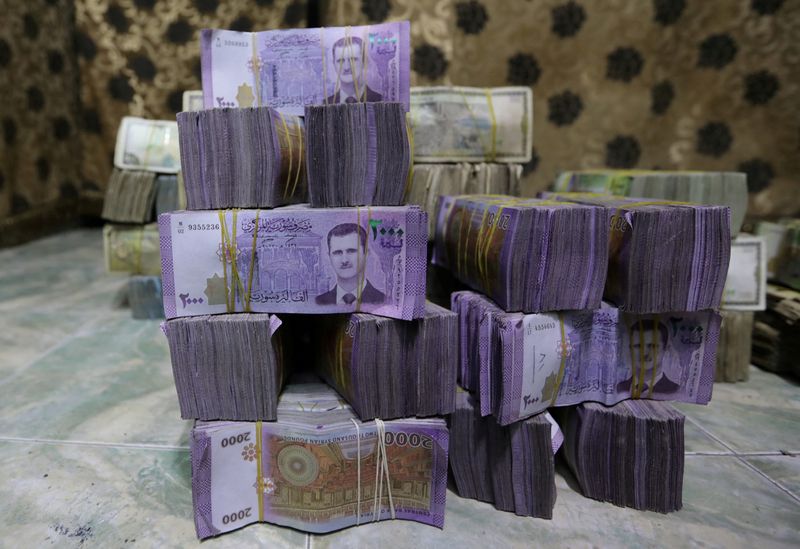 Exclusive-Syria to revalue currency, dropping two zeros in bid for stability, sources say