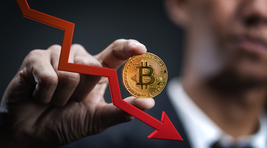 Decreasing Value of Bitcoin. Businessman Holding Bitcoin With Red 3D Arrow Down