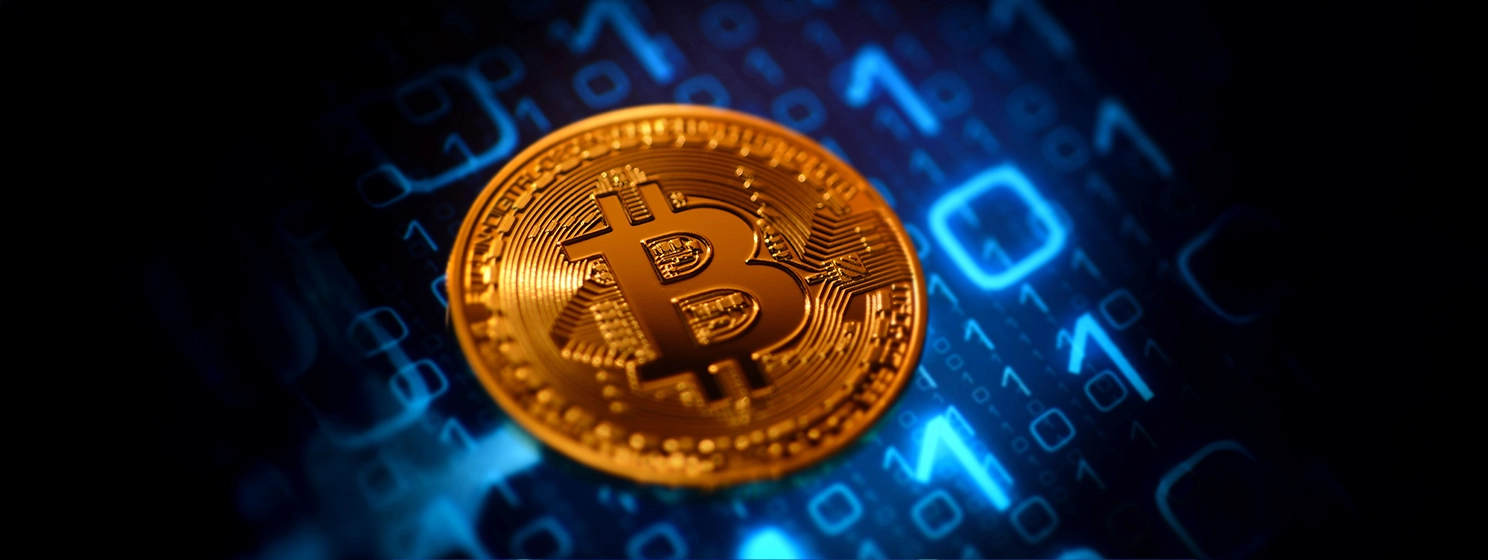 Close up of physical bitcoin over abstract background.