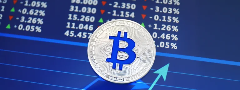 Silver bitcoin on screen with chart.