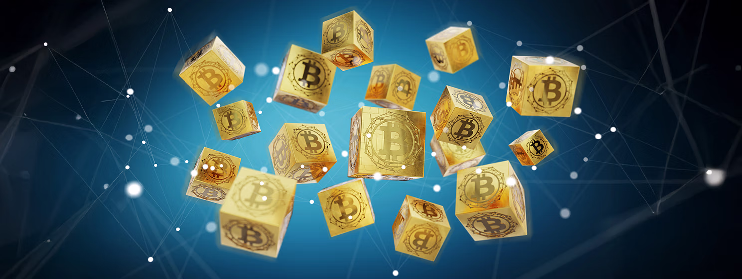 Bitcoin logo printed on gold blocks.