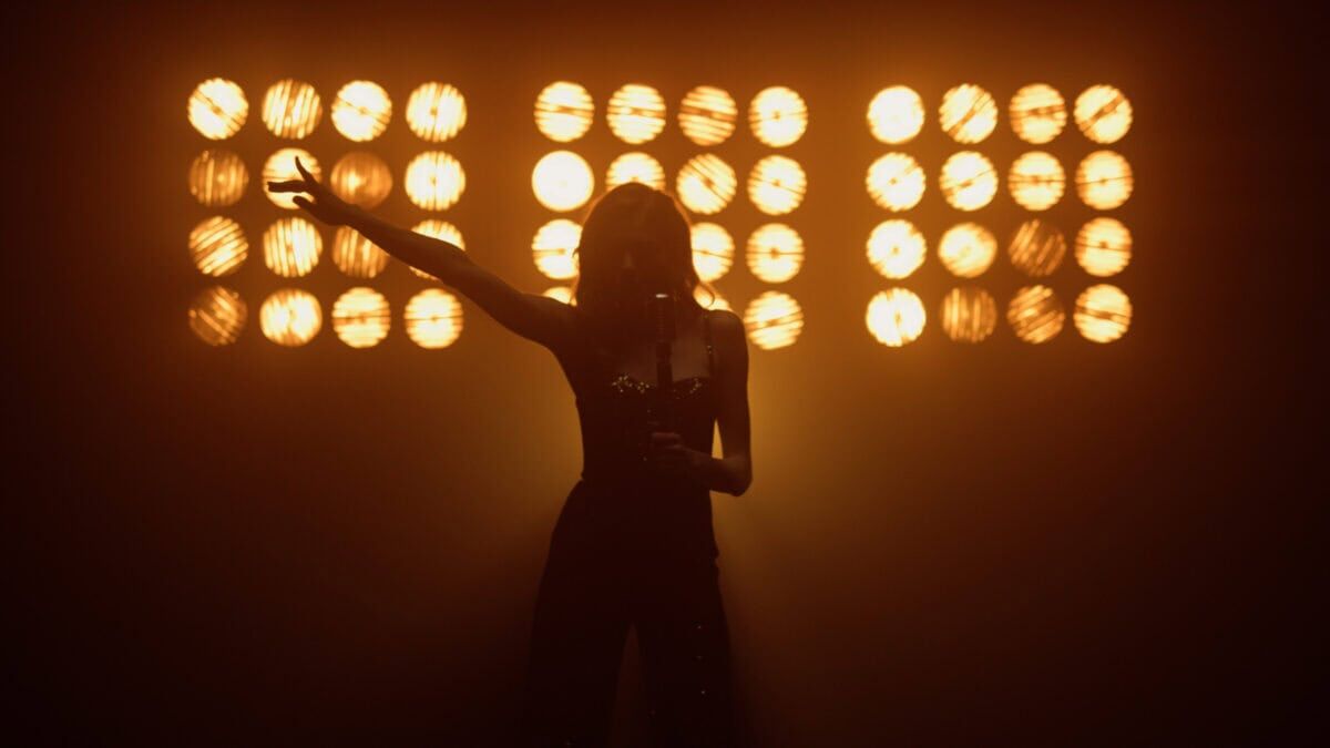 dancer in front of lights brings excitement and heat
