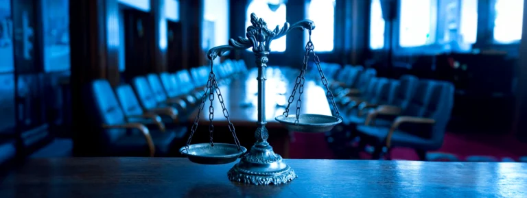 Decorative Scales of Justice in the Courtroom banner