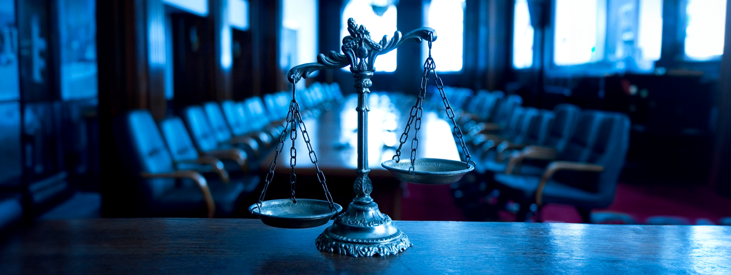 Decorative Scales of Justice in the Courtroom banner